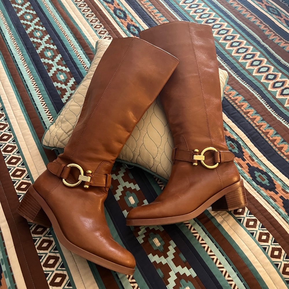 Coach leather boots in tan cognac color with side zip and buckle details.